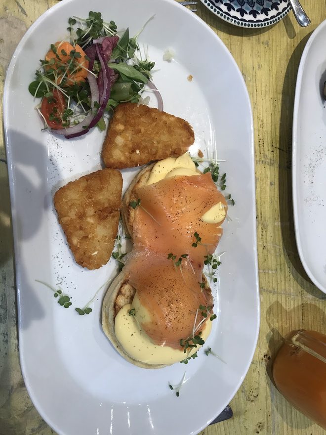An oval plate of eggs benedict with halloumi