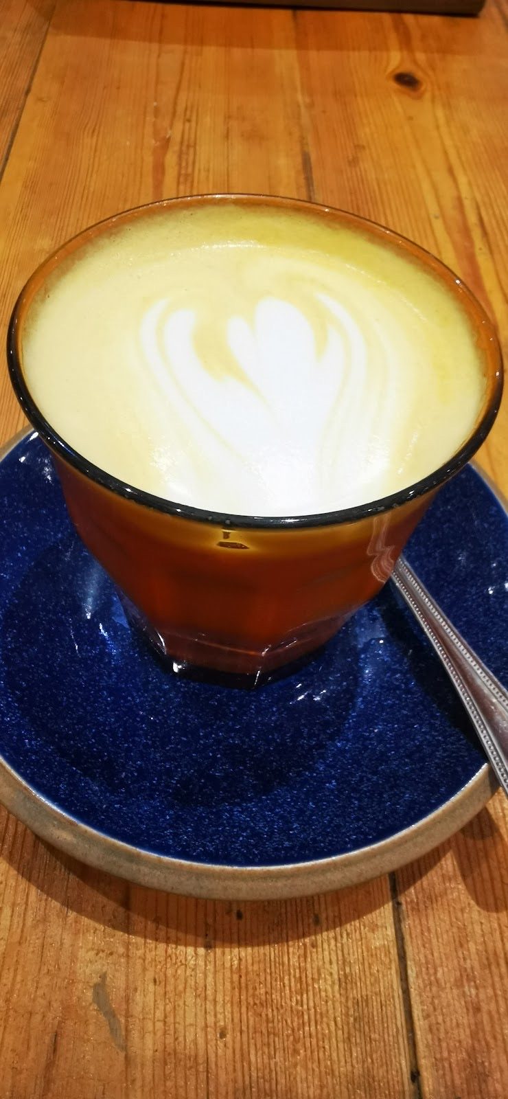 A flat white with rosetta latte art